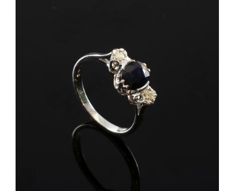 Sapphire and diamond three stone ring, central sapphire weighing 1.40cts flanked by two round brilliant cut diamonds, mounted