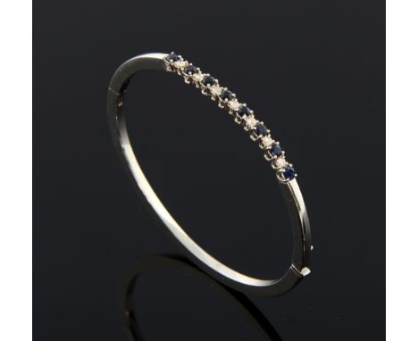 Sapphire and diamond hinged bangle set with eight round-cut sapphires and seven diamonds, total diamond weight  0.28cts, unma