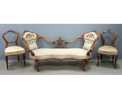 19th century carved walnut parlour suite comprising, double ended button back stette with floral carved show frame and set of