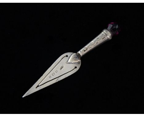 George V silver bookmark of trowel form with thistle form handle set with purple stone, Birmingham 1910