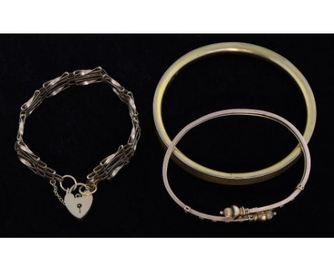 Victorian gold bangle with acorn finial, another  with engine turned  decoration  and a modern gate bracelet