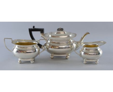 Edward VII silver three piece tea service, comprising teapot, cream jug and sugar bowl, with gadrooned rims on ball feet, by 