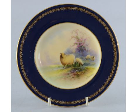 Royal Worcester cabinet plate painted by E Barry decorated with sheep on highland background, blue and burnished gold border