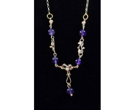 Amethyst and gold necklace, the centre set with five round amethyst beads with open gold scroll work to a 9ct gold belcher ch