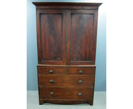 19th century Mahogany linen press, the top with two cupboard doors enclosing four trays, over base with two short over two lo