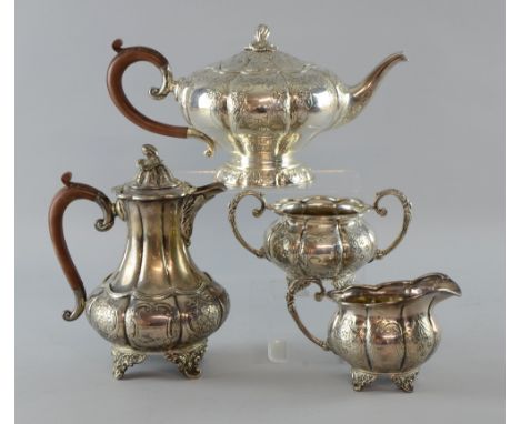 George V silver four piece tea service, comprising teapot, hotwater jug, cream jug and sugar bowl, of lobed form with engrave