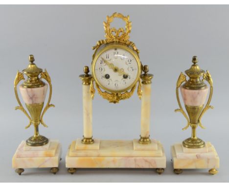 French Mantle clock with a matching garniture on marble columns and step base.  White enamel dial striking on the bell