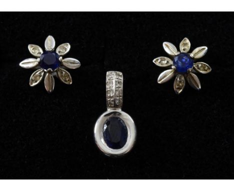 Sapphire and diamond pendant and a pair of sapphire earrings in floral setting both 18ct white gold