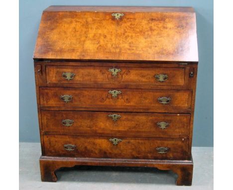 19th century walnut and crossbanded bureau, fall flap revealing cupboard door, pigeon holes and four drawers over four long g