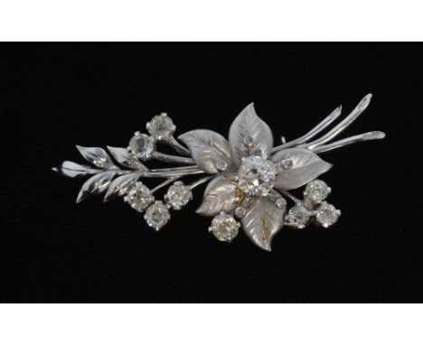 A diamond set spray brooch, old cushion cut diamond to centre weighing approximately 0.50cts. Mounted in 18ct white gold Tota
