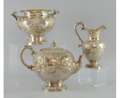 Victorian Scottish silver three piece tea service, comprising teapot, cream jug and sugar bowl, with embossed decoration, by 