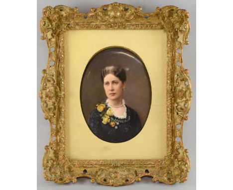 19th century Dresden porcelain oval plaque painted with a bust length portrait of a woman in a black dress, pearl necklace an