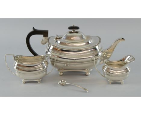 George V silver three piece tea service, comprising teapot, cream jug and sugar bowl, with gadrooned rims on four bun feet, b