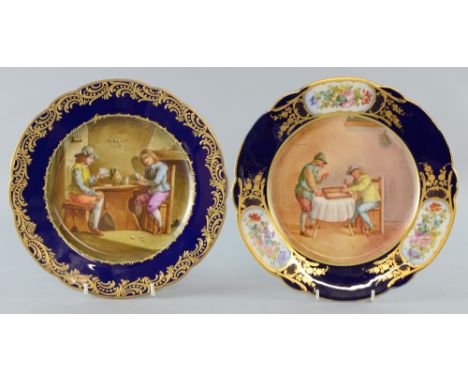 Two Sevres plates handpainted, one with figures in a tavern, the other with figures playing backgammon on a blue background w