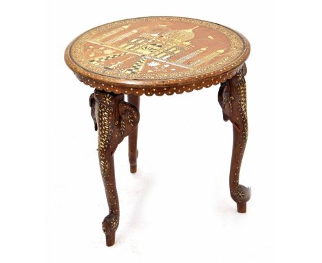 Indian inlaid circular occasional table, the top decorated with a palace front within a foliate border, raised on three eleph