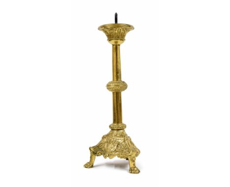 Antique brass ecclesiastical candlestick, raised on a trefoil base with repousse panels of a winged angel, upon three paw fee