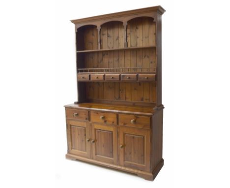 Stained pine dresser, the galleried shelf raised back over base section of three short drawers over single and double cupboar