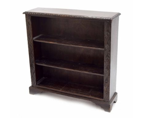 19th century carved dark oak open bookshelf, with two shelves flanked by carved foliate pilasters upon bracket feet, 37.25" w