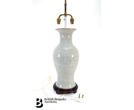 Pair of 20th century cream crackle glazed lamp bases, baluster form, approx 44 cms, with a double bulb fitting.&nbsp;