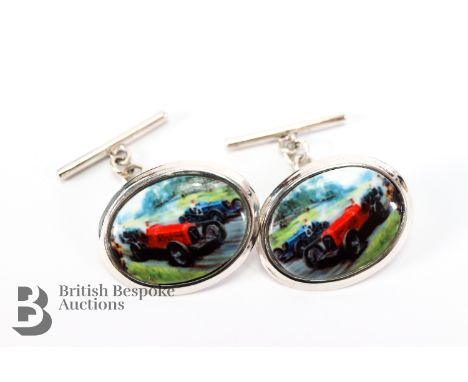 Pair of silver cufflinks, set with an enamel plaque depicting racing vintage Bugatti cars.&nbsp;