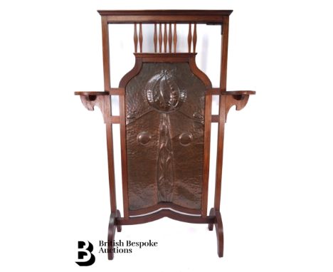Oak fire screen, with an Arts and Crafts hammered copper central panel with a poppy motif, approx 52 w x 100 h cms.&nbsp;