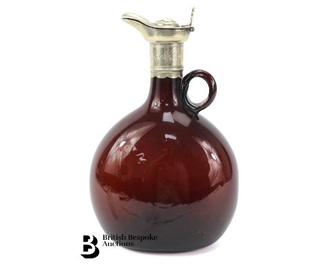 Victorian brown blown glass bottle flask/decanter, of circular form with a white metal collar, spout and cover, shell-form th