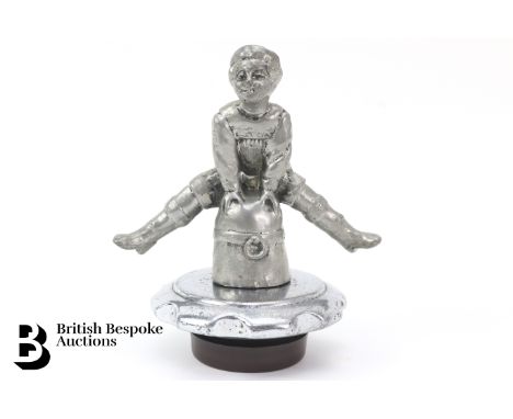 An interesting and rarely offered accessory mascot, date stamped, featuring a quality accessory mascot of a girl vaulting a r