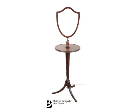 Late Victorian mahogany shaving stand, with a shield-form mirror raised on tripod feet, approx 40 cms diameter to the shaving