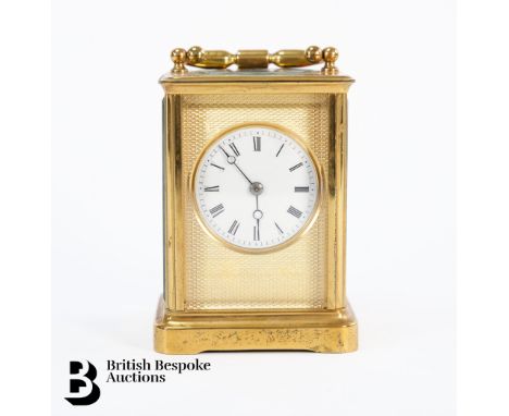 Gilt brass carriage clock, with white enamel face and Roman dial, bevelled glass panels, 8-day movement strikes to a bell, br