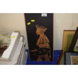 A wooden engraving of a Zulu warrior, signed lower left