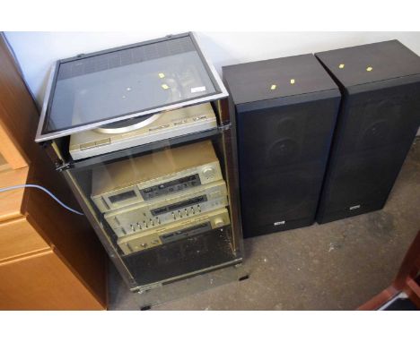 Vintage Akia stereo in cabinet with accompanying speakers