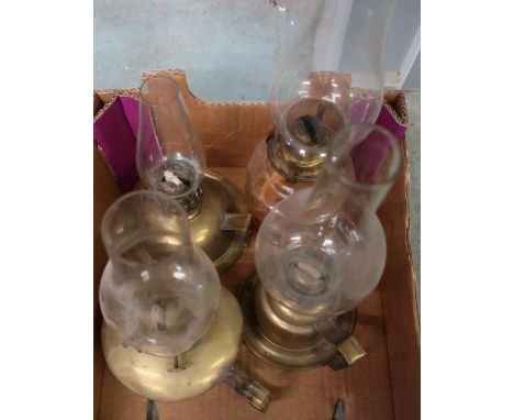 Early 20th C 'Go to Bed' oil lamp with glass reservoir and three brass bodied 'Go to Bed' oil lamps 