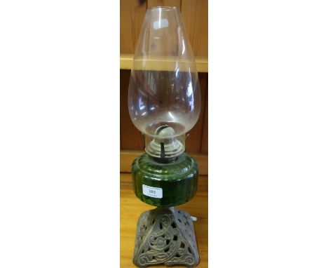 Early 20th C oil lamp with green glass reservoir and cast metal base 