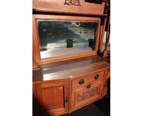 Art Nouveau light oak dresser with raised bevel edged mirror back and carved detail, with central drawer above fall front wit