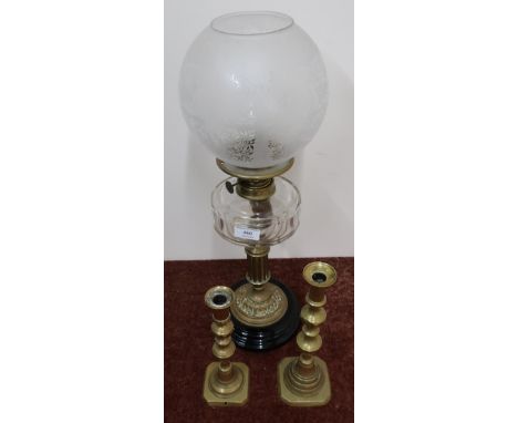 Late Victorian oil lamp with clear glass reservoir and fluted column on glazed porcelain base, and two 19th C candle sticks 