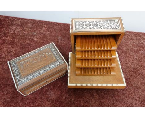 Middle Eastern inlaid hardwood musical cigarette box with three tier graduated interior and a similar carved eastern hardwood