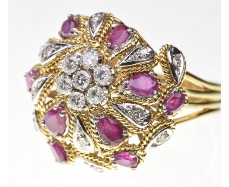 A ruby and diamond bombe dress ringSet to the centre with a diamond cluster of round brilliant-cut diamonds, to a swirl surro