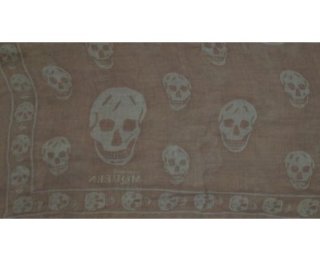 An Alexander McQueen 'Skull' scarf The light brown/purple scarf with printed pale blue skull design, 45cm x 110cm. 
