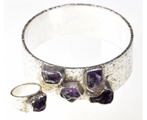 A gem-set studio bangle and matching ringThe hammered white metal set with irregularly-cut and bezel set amethyst-style stone