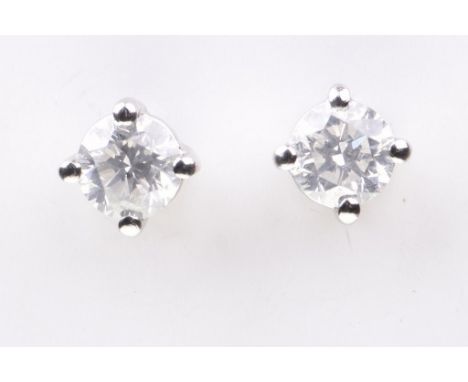 A pair of diamond ear studsEach round brilliant-cut diamond, four claw set, mounted in platinum, with ear posts and butterfly