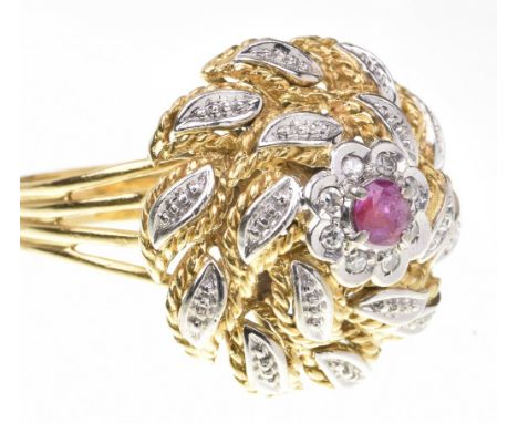 A ruby and diamond bombe dress ringThe centre set with a circular shaped ruby, to a single-cut diamond cluster, to a bi-colou