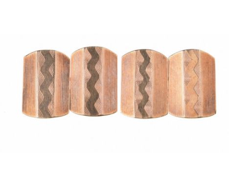 A pair of 9ct gold cufflinksOf shaped rectangular form, with engine turned decoration to both panel, with chain link, length 