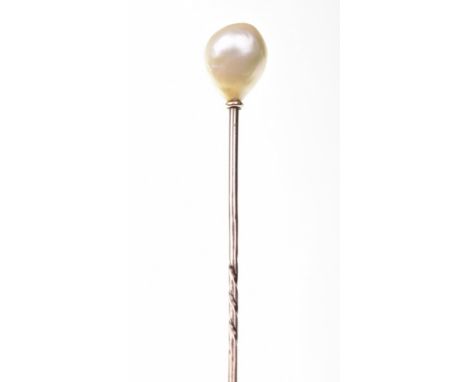 A natural pearl stick pinThe stick pin with a 10.7mm x 8.4mm x 8.0mm pearl finial, length 7.7cm.N.BAccompanied by a report fr