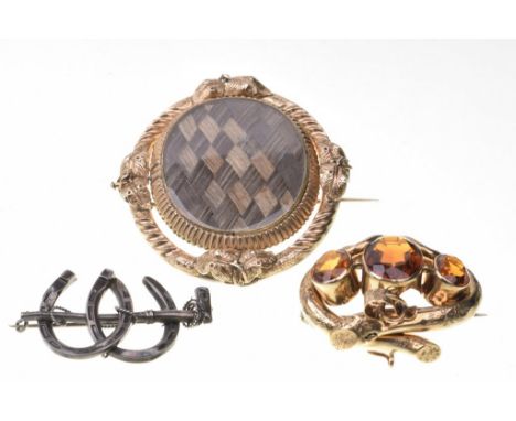 A Victorian double sided spinning mourning broochThe large oval brooch, each side with hair work designs, to an unmarked yell