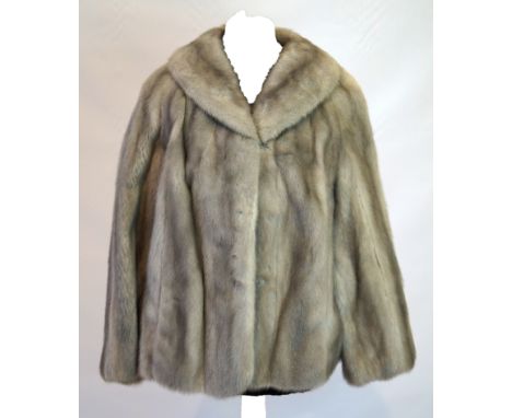 A ladies grey mink swing jacket The vertical pelts of light to dark grey colour, with swept collar and full length sleeve and