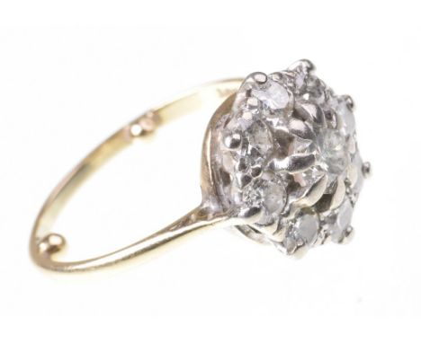 A diamond cluster ringThe central round brilliant-cut diamond, to a similarly cut diamond surround, to a plain yellow metal b