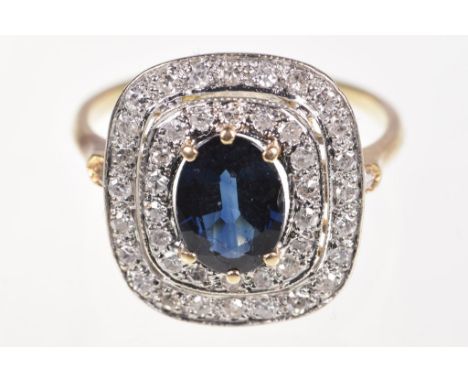 A diamond and sapphire cluster ringThe oval-shaped sapphire centrally set to a double row single-cut diamond rectangular surr