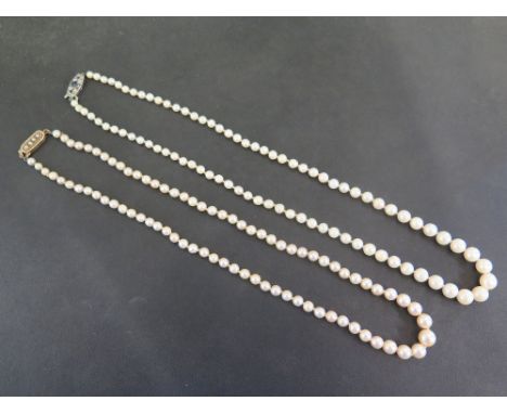 Two cultured pearl necklaces - One with a seed pearl clasp stamped 9ct - One with a paste-set clasp stamped 925 - Length 47 a