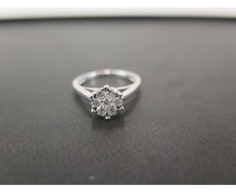 A brilliant-cut diamond daisy cluster ring - Stamped 750 (18ct) - Ring size K - Weight approx 2.9gms
Condition Report: Good -