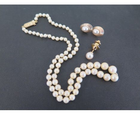 A pair of 9ct gold ear studs each set with a mabe pearl - Weight approx 1.0gms - A cultured pearl dress stud - Stamped K18 - 